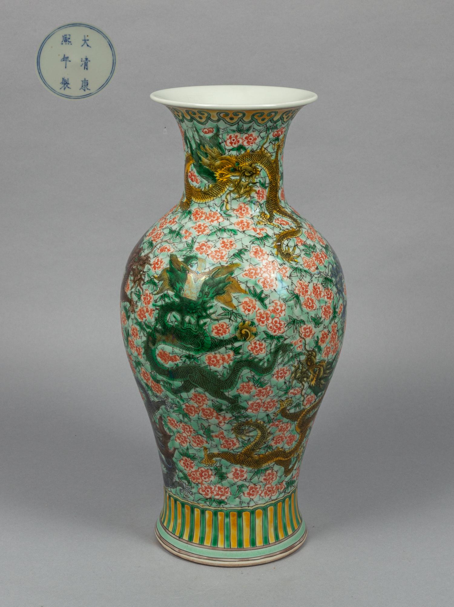 Chinese Famille Rose Porcelain Dragon Vase: The exterior painted with polychrome coiled dragons on a light green ground with dense flowers and streaks, base with a six-character mark in double circles. 16*7.3inch.