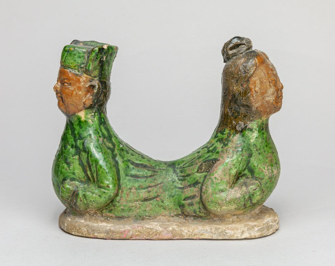 Chinese Glazed Porcelain Pillow: Modeled as two connected figures with upright heads, applied in green, red, and black glazes. 7.5*6*3.7inch.