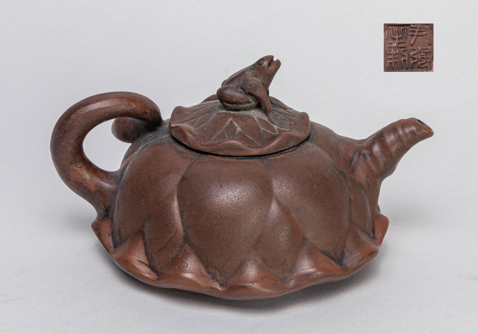 Chinese Yixing Zisha Tea Pot: Overall worked in the form of lotus, the cover with a toad type knob, base with a seal mark. 6.3*5*3.7inch.