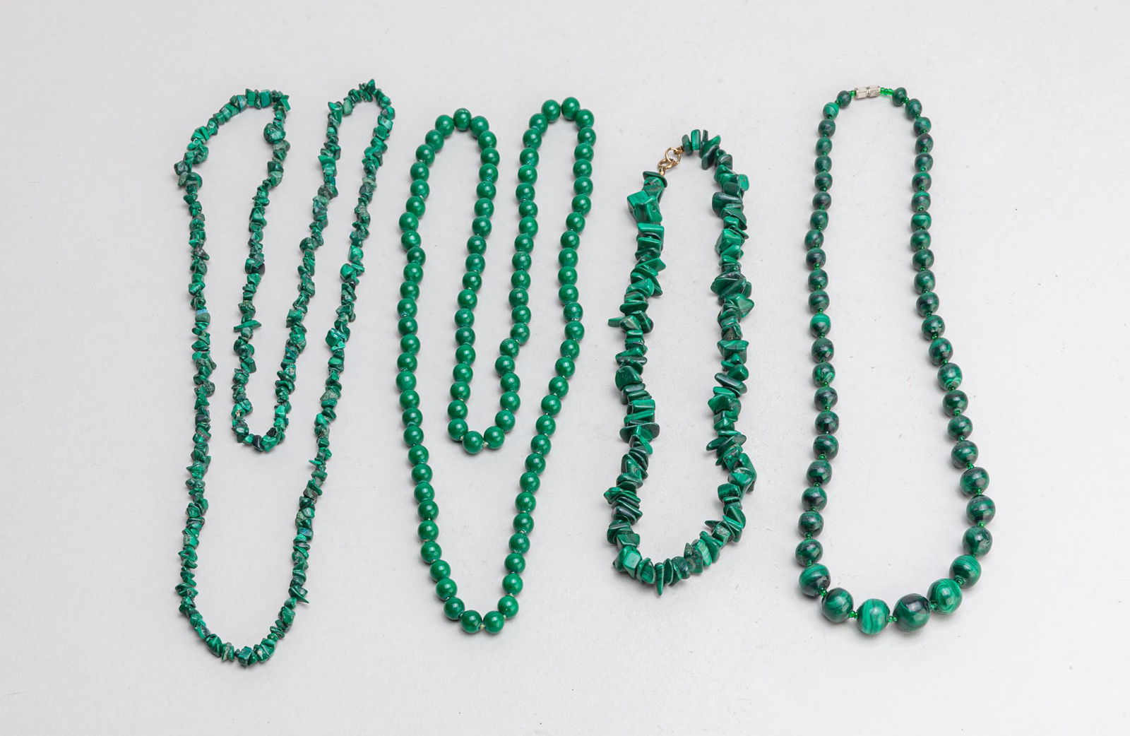 Collectible Old Malachite Necklace: Group of 4 collectible malachite necklaces, malachite is a copper carbonate hydroxide mineral, opaque and green-banded. 35inch L (largest).