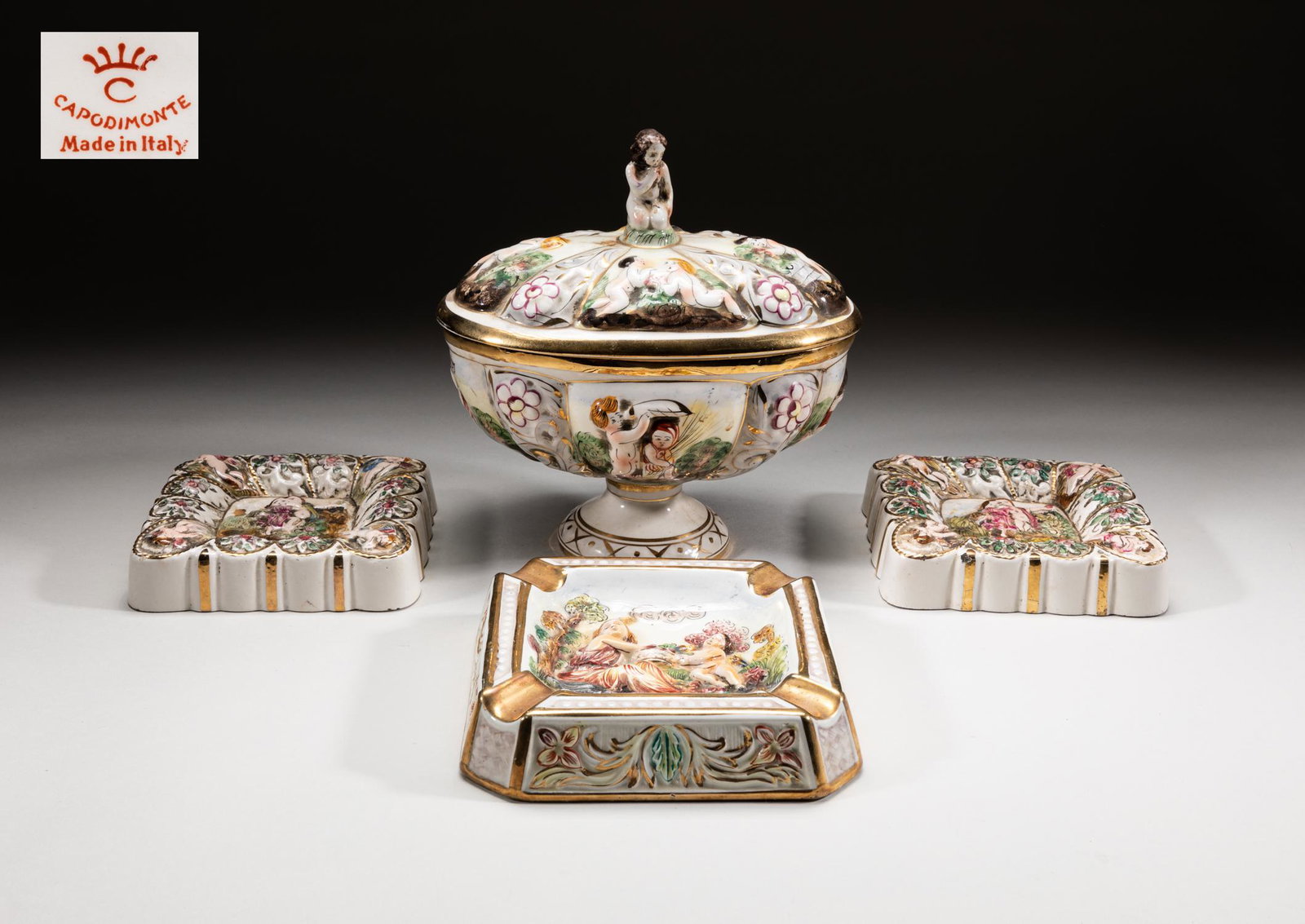 Italy Capodimonte Bone China Wares: Group of Italian type bone china dinnerware and decors, carved and enameled with figures, flowers and foliates scrolls, each base marked Capodimote. 8.2inch H, 8inch L, 5.3inch W (largest).
