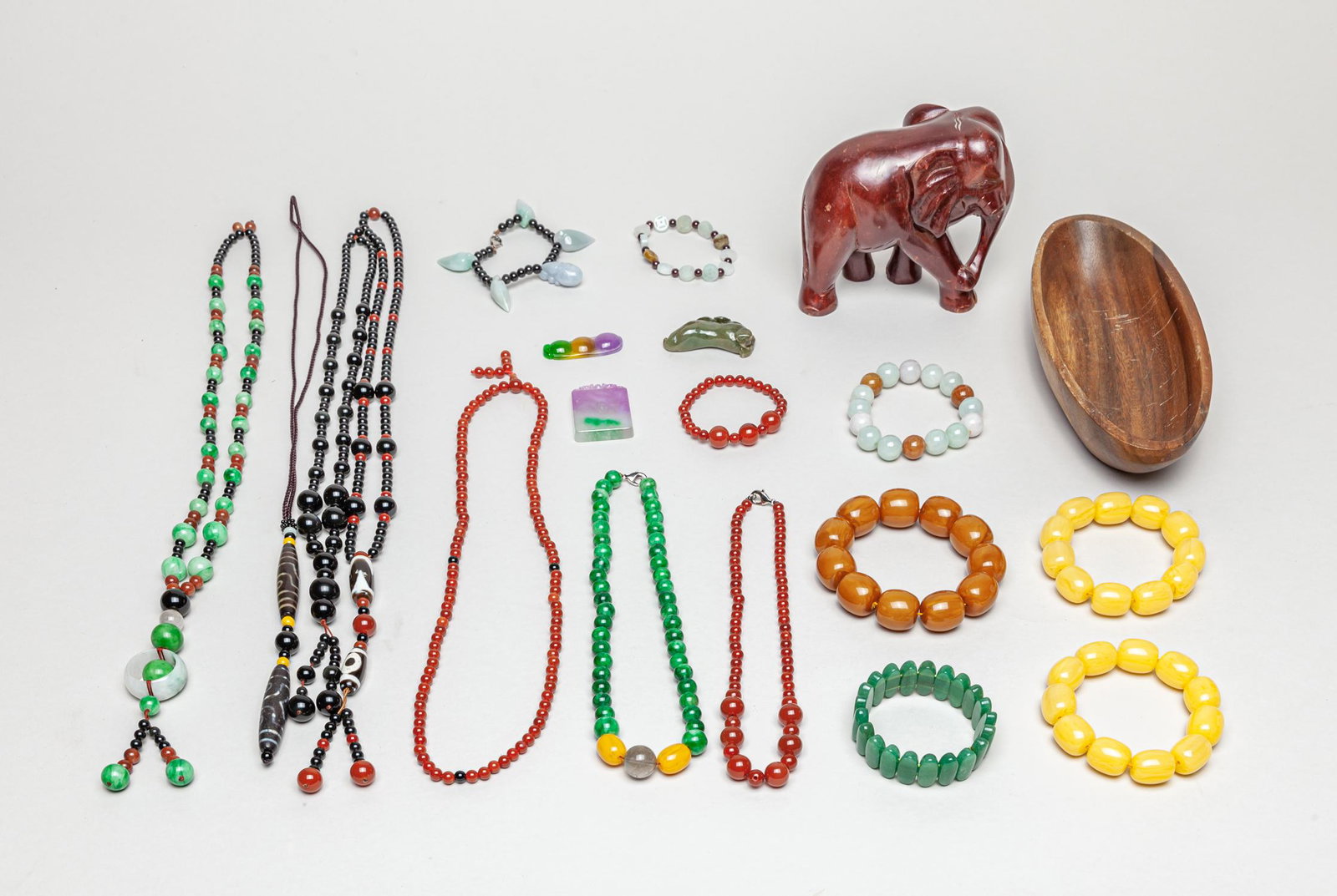 Estate Chinese Jade/Gem Stone Jewelries & Decors: A large group of jade/gemstone and wood jewelries, including bracelets, pendants, necklace, dzi beads, a wood elephant and a wood bowl. 28inch L (largest).