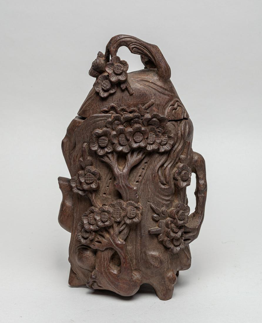 Chinese Carved Bamboo Covered Pot: The trunk-shaped body and cover carved in high relief with blooming flower tree branches. 11inch H, 6.2inch L, 4.5inch W.