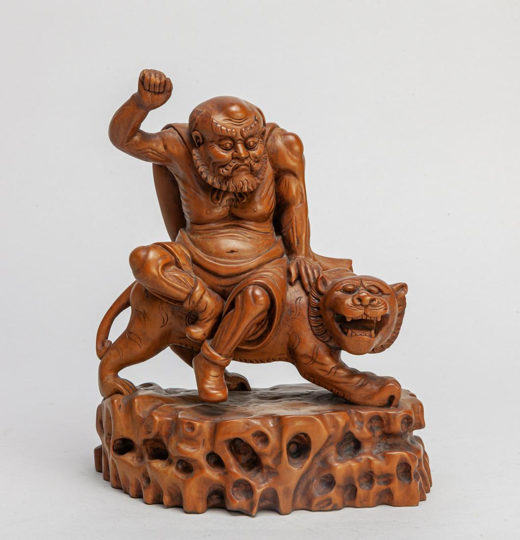Chinese Boxwood Carved Figure of Luohan & Tiger: Carved as a Lohan wearing a cloak, seated on a beast on a rock type base. 8.5inch H, 7inch L, 4inch W.