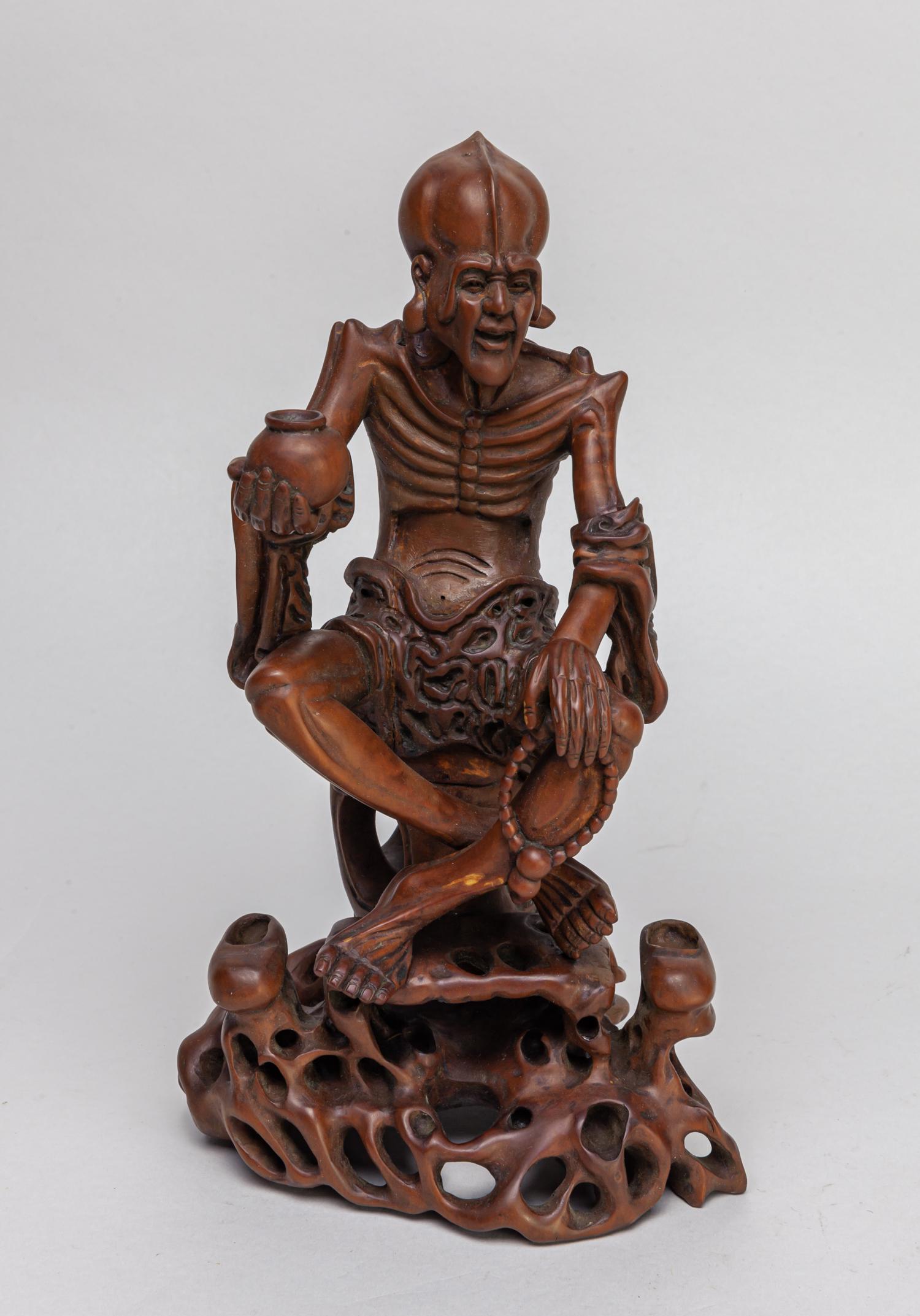 Chinese Boxwood Carved Figure of Luohan: Carved as luohan with left hand carrying prayer beads and right hand holding a bowl. 10.2inch H, 5.9inch L, 4.4inch W.