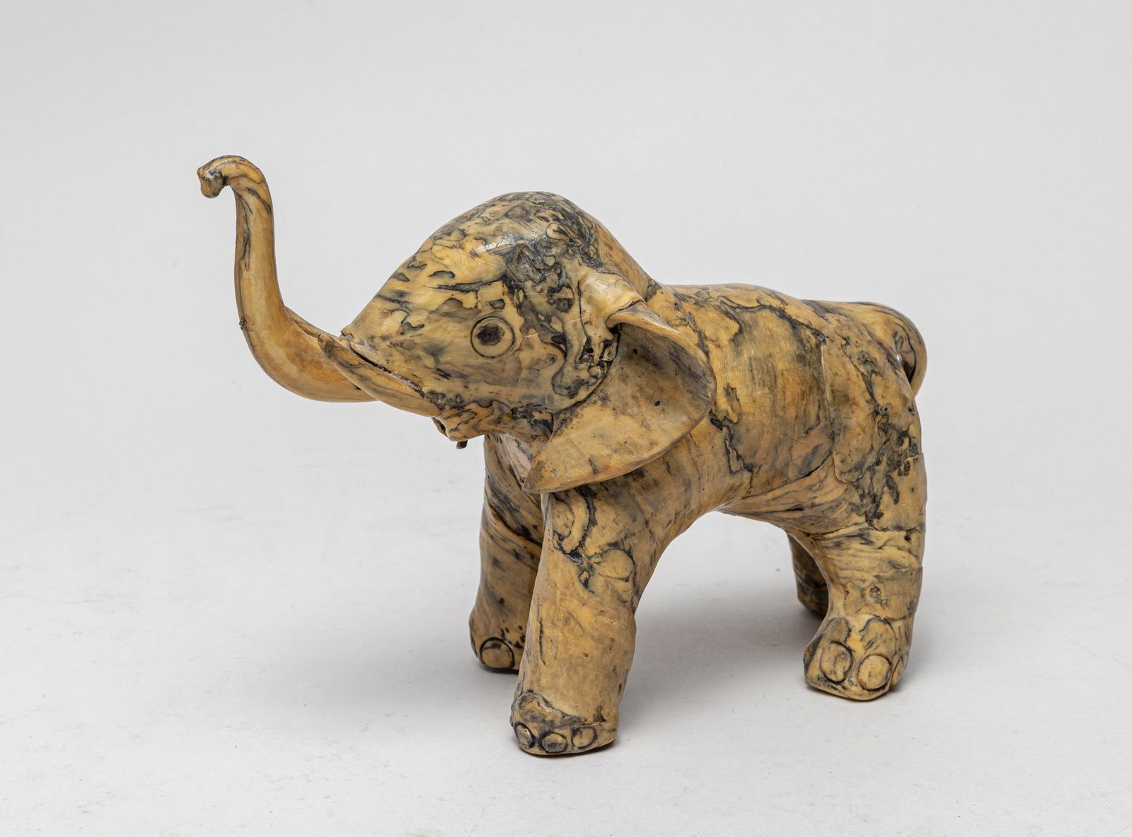 English Type T- Shell Like Elephant Sculpture: Decorative T-shell like elephant type table sculpture, with its nose lifting upwards. 9.7inch L, 4.7inch W, 6.8inch H.