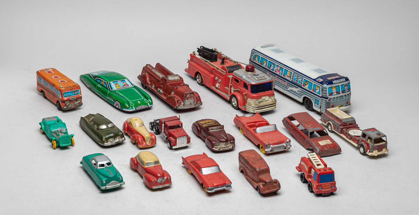 Collectible Vintage Toy Cars: A large group of vintage toy cars, wherein two pieces marked school bus and Greyhound. 11.2inch L, 3inch W, 3inch H (largest).