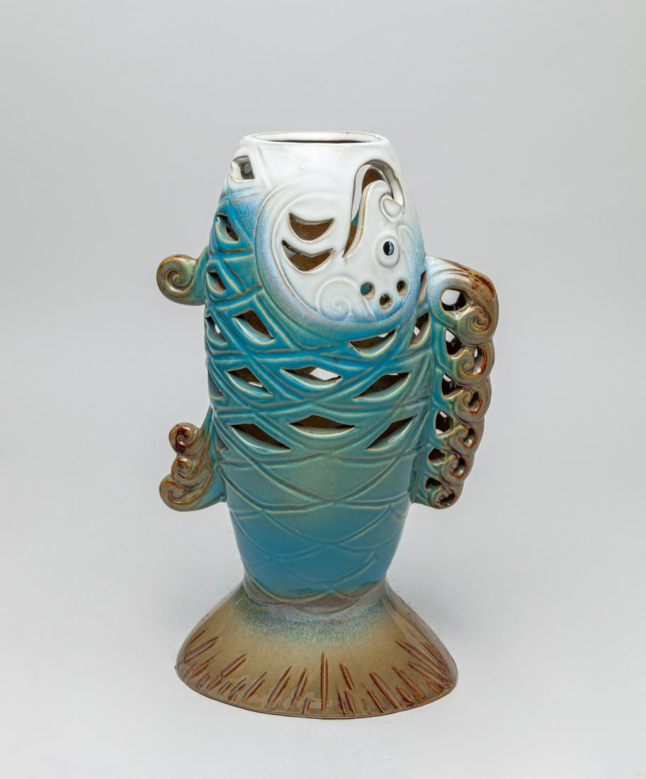 Designed Art Flambe Glazed Porcelain Vase: In form of standing fish, finely carved and pierced, the exterior applied with glazes in white, blue and brown coloration. 12.6inch H, 7.6inch L, 4.4inch W.