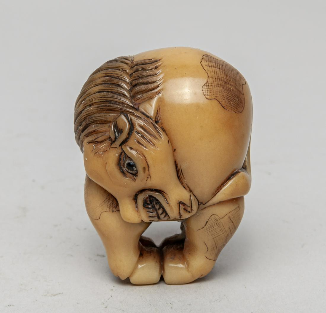 Japanese Taisho Vegetable-ivory Netsuke: Well-carved as a horse with its head turned downwards and body huddling up. 1.8inch H, 1.35inch L, 1.2inch W.