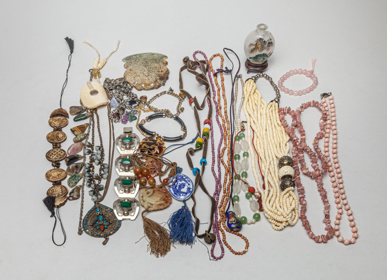 Collection of Chinese Vintage Necklace & Jewelry: Large collection of necklaces, bracelets, toggles and an inside painted snuff bottle with wood stand, the jewelries comprised of gemstones, bone, jade/stone, decor beads, and blue and white porcelain.