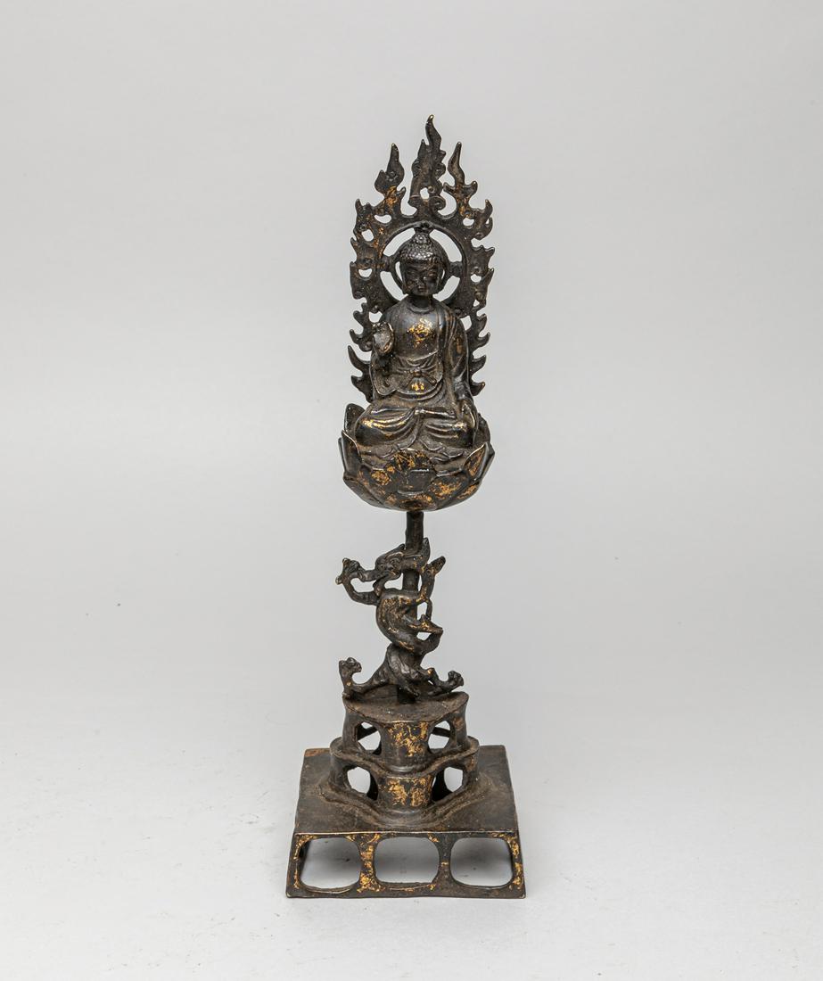 Collectible Chinese Gilt Buddha: Cast seated in dhyanasana on a lotus pedestal rising on a stalk from a square stand, the hands resting in bhumisparsa mudra and vitarka mudra, with a flaming halo to his back, a dragon twined around t