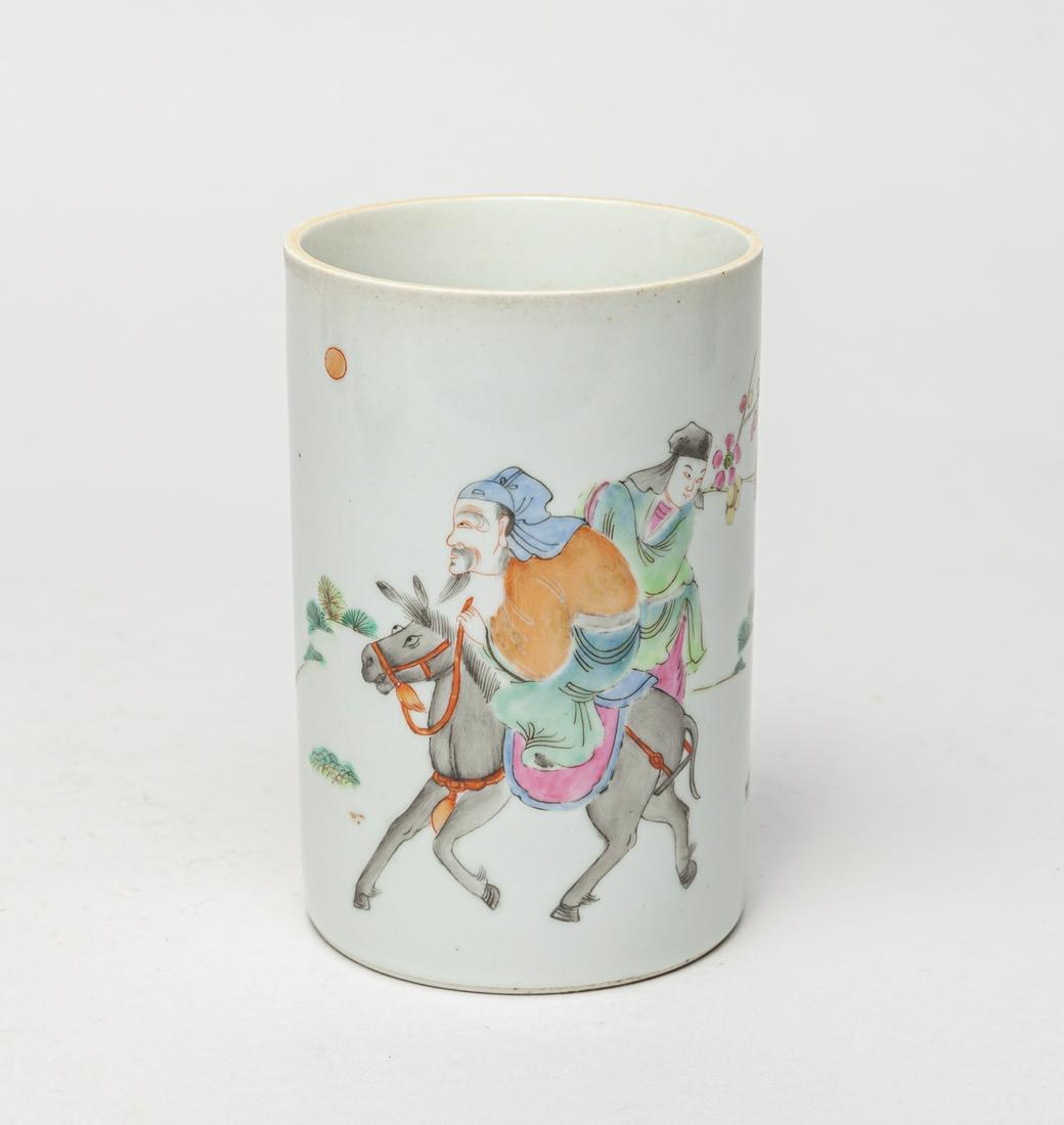 Chinese Famille Rose Porcelain Brush Pot: The cylindrical body painted with a scene of one figure riding on a donkey, and the other holding flower branches. 4.8inch H, 3.2inch D.