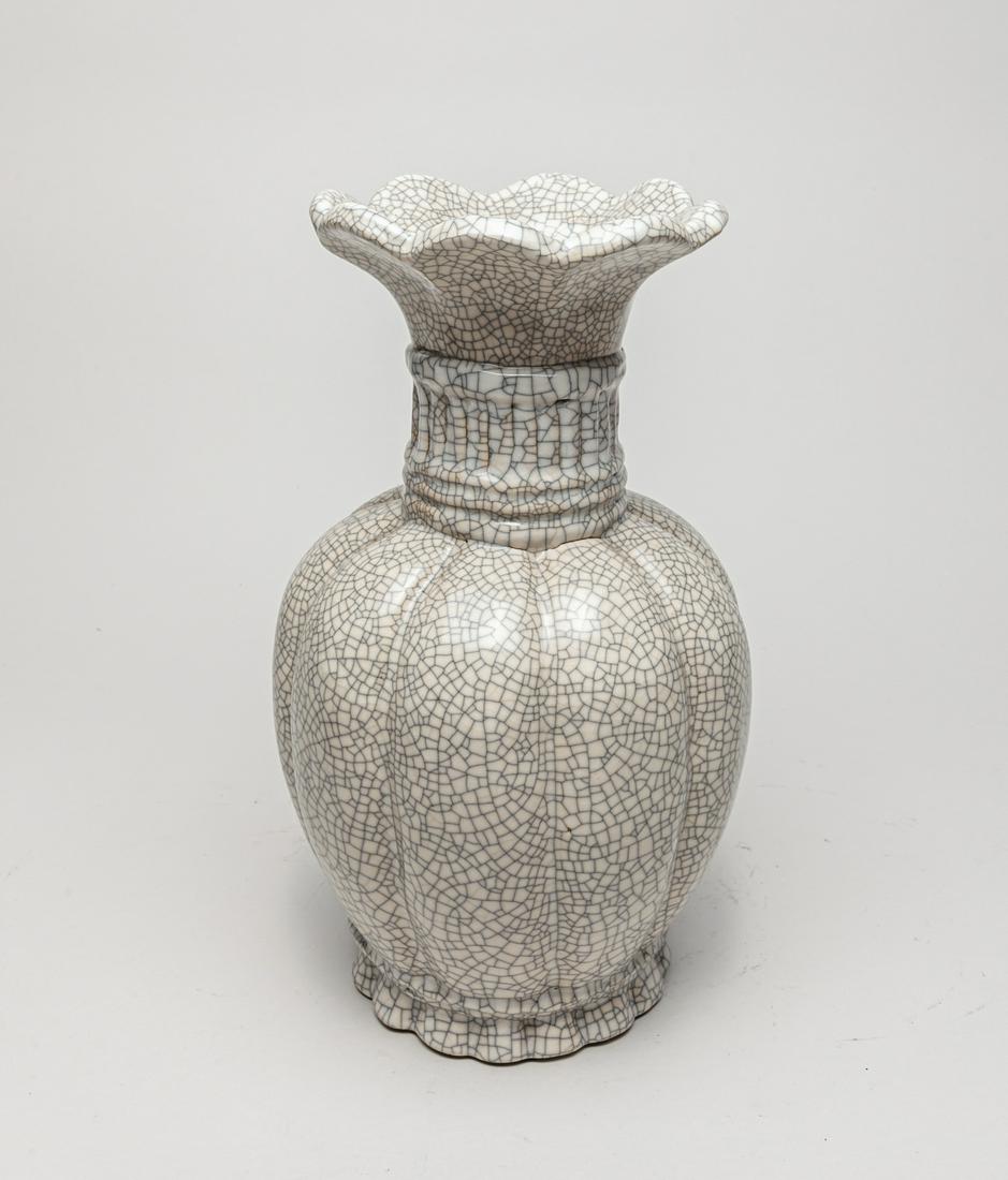 Chinese Ge Type Porcelain Cabinet Vase: Worked in fruit form wit an eight-lobed flaring rim, the exterior and interior neck covered with a glaze in creamy tone suffused with a matrix of brown crackles. 12.5inch H, 7inch D.