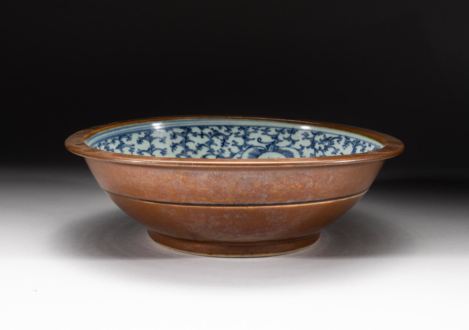 Massive Chinese Blue & White Porcelain Pot: Th interior painted with large blooms among curly leafy scrolls, the exterior and interior rim applied with an even brown glaze except the foot ring, with a thin band around the sides. 10.4inch D, 3.2