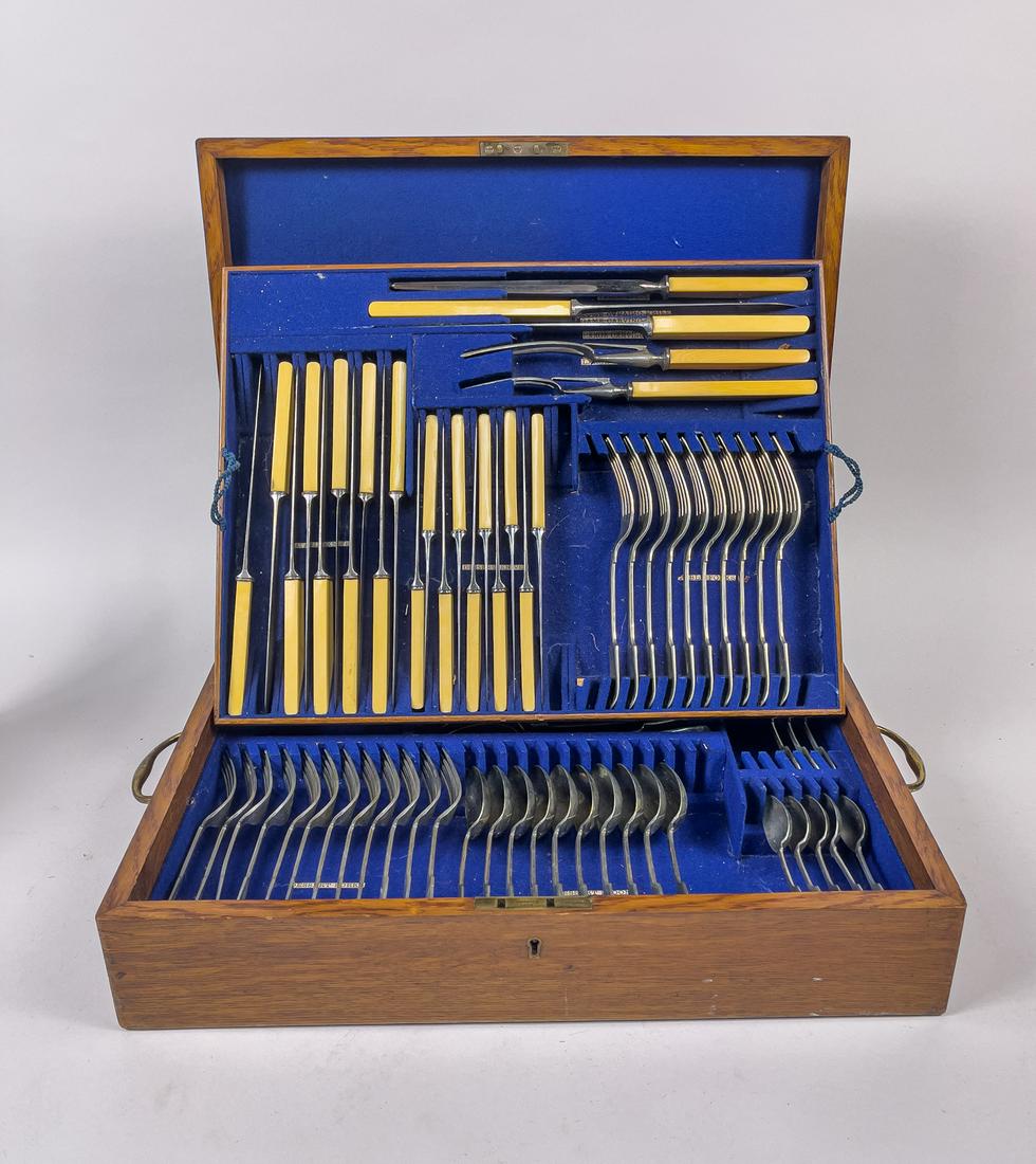 Vintage Silver Color Flatware w/Oakwood Box: A large group of rare collectible silver-colored knives, spoons, and forks, with oakwood box. 18.25inch L, 14inch W, 4.5inch H (box size).