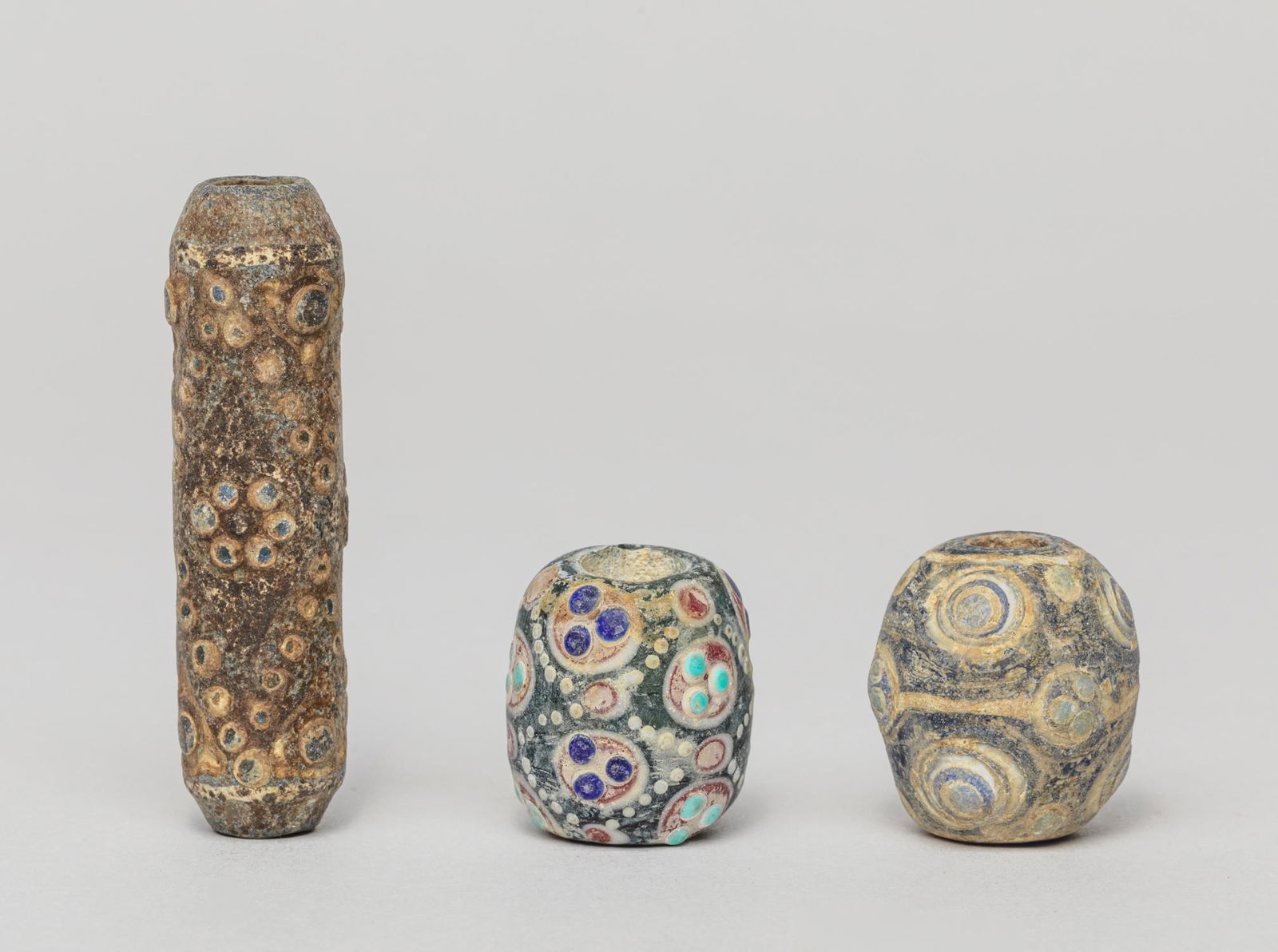 Group Antique Roman Type Dragon-fly Glass Beads: Group of three old Roman type dragonfly eye glass bead, wherein one of elongated shape. 2.08inch H, 0.55inch D (largest). The Estate of the P. H. Schooman, Beverly Hills, CA