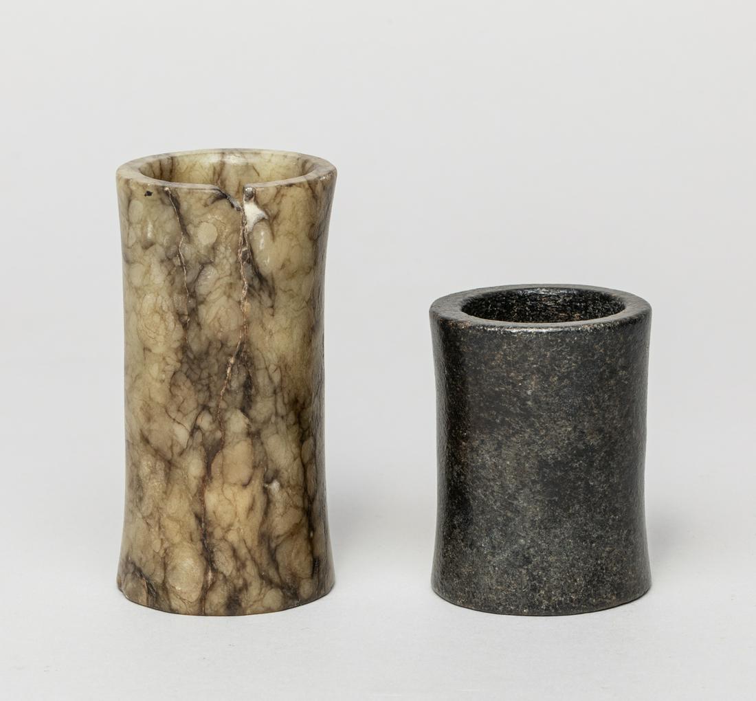 Ming Type Tall Chinese Jade Carving Gu: Both of archaic gu form with silghtly waisted body, one carved the stone of mottled chicken bone and brown hues, the other with mottled black jade. 3.28inch H, 1.7inch D (larger). The Estate of the La