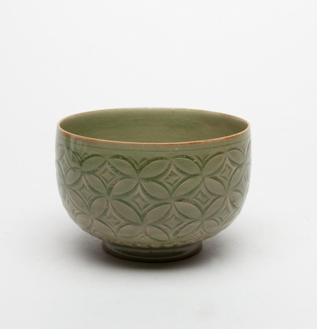 Collectible Large Chinese Yaozhou Bowl: The rounded sides swiftly incised around the exterior with continuous cash coins above a band of chrysanthemum petals at the foot, overall covered with an olive-green glaze. 3.3inch H, 5.1inch D. The 