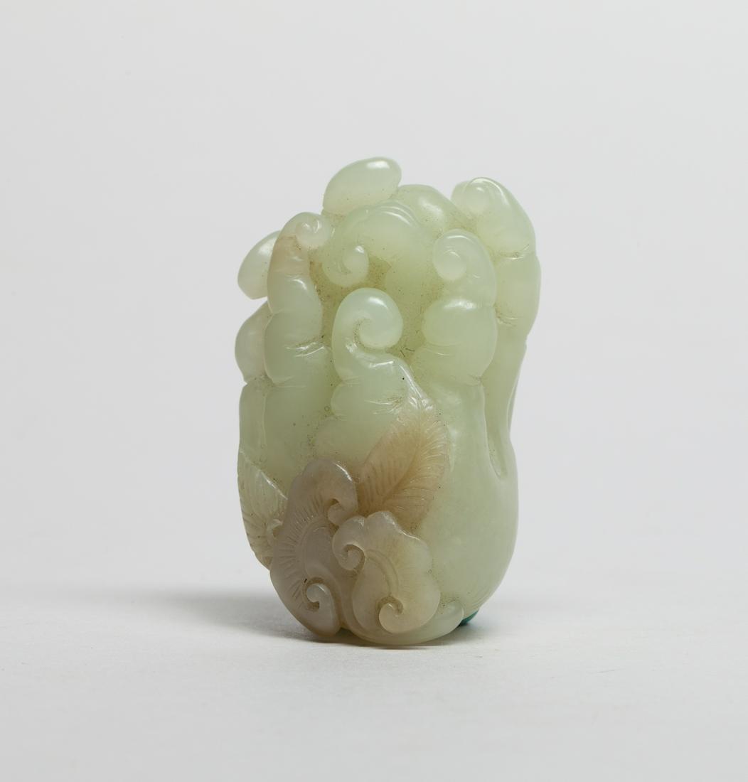 Chinese Jade Carved Buddha Hand: Skillfully carved buddha hand borne from a stem issuing lingzhi and leaves , the stone in a pale celadon tone with russet inclusions. 2.4inch L, 1.45inch W, 1.2inch H.