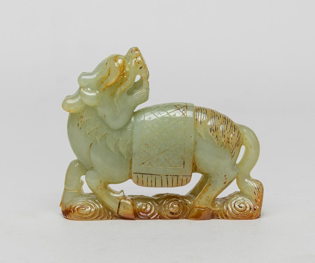 Chinese Russet Jade Qilin: Carved as a mythical qilin standing on scrolling clouds, its head turned backwards, the open mouth revealing its teeth and tongue, finely incised mane and tail, with a rug on its back, The stone in va