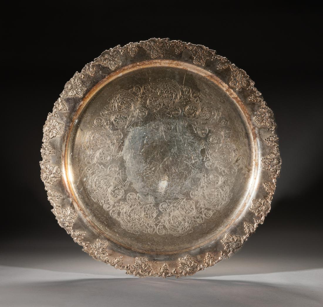 Collectible Massive Silver-Plated Charger: Massive vintage type silver-plated charger, the rim moulded with continuous grape vines issuing grapes and leaves, the interior incised in low relief with a band of curled leaves enclosing blooming fl