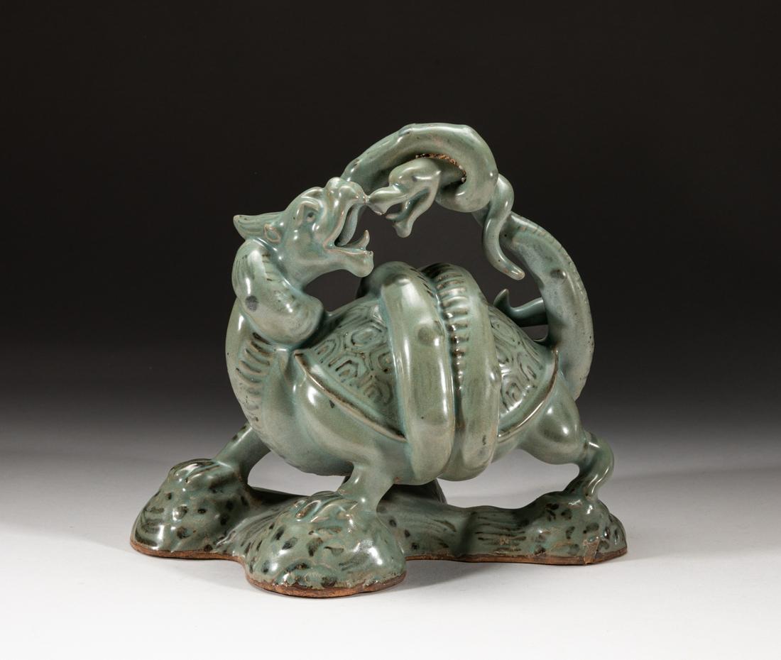 Rare Korean Celadon Porcelain Table Sculpture: The turtle crouching and twisting its head turned sharply backwards, with the snake wrapped around its body and rearing high overhead, the tension between the creatures made palpable through the fearf