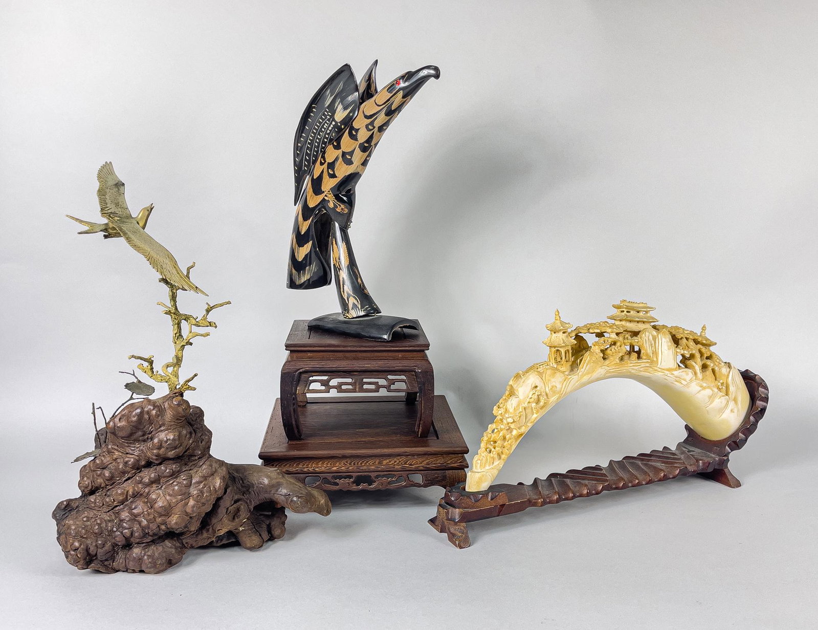 Collectible Chinese Table Sculptures: Group of 3 Chinese collectible table sculptures, one horn carved eagle with two wood stands, one bone like carved sculpture and one root with crane, minor chips. 17.5inch L, 9.5inch W (largest).