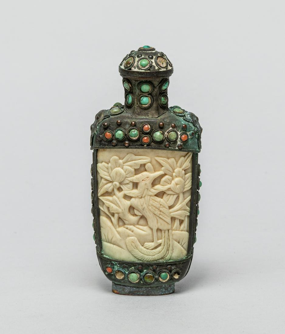 Collectible Chinese Snuff Bottle Inlaid Bone: Of flattened form, each side inlaid with a bone panel carved with a bird with long tail standing among flowers, the metal body inlaid with various stone, with matched stopper. 4inch H, 1.77inch W.