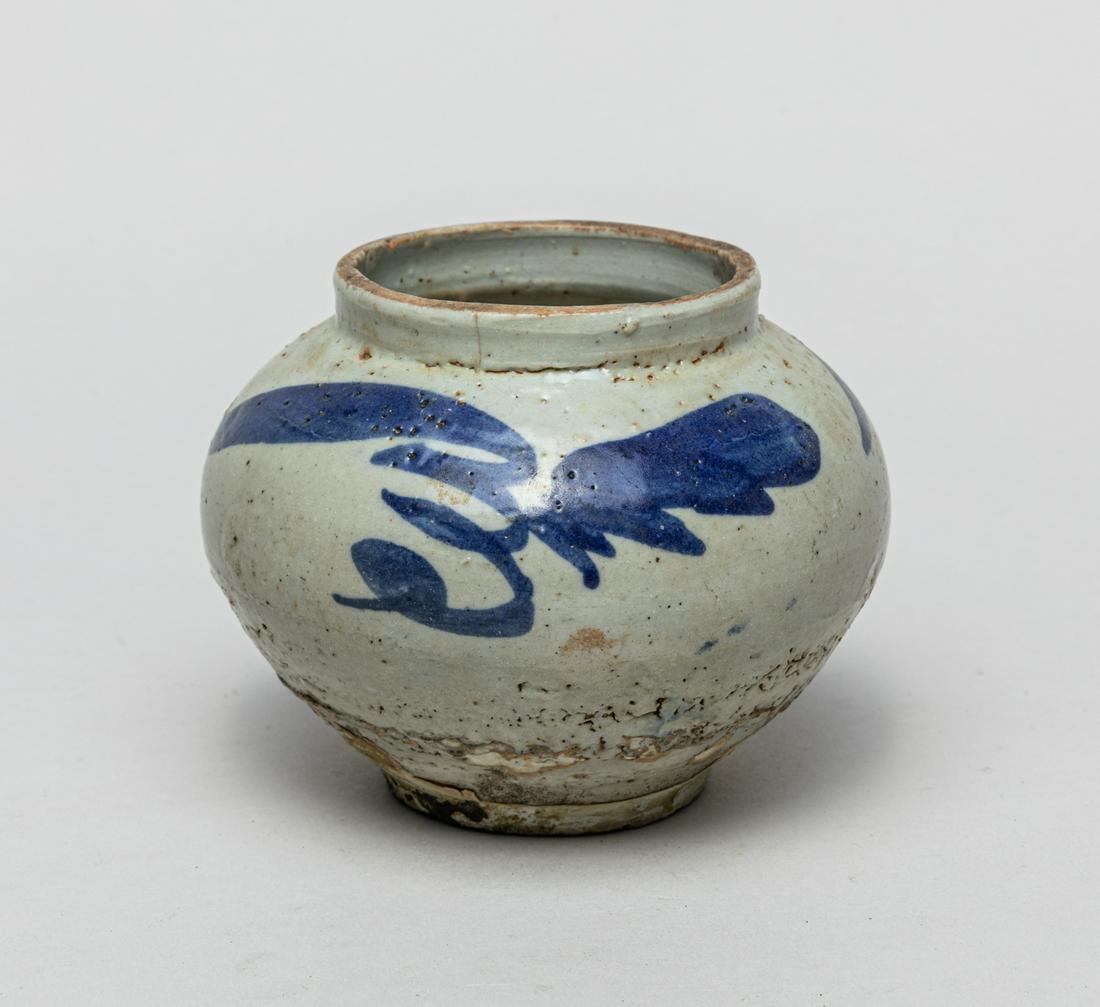 Old Korean Blue & White Porcelain Jar: The ovoid body with a tapered foot and a broad short neck, the exterior painted with stylized flowers. 4.4inch W, 3.4inch H.