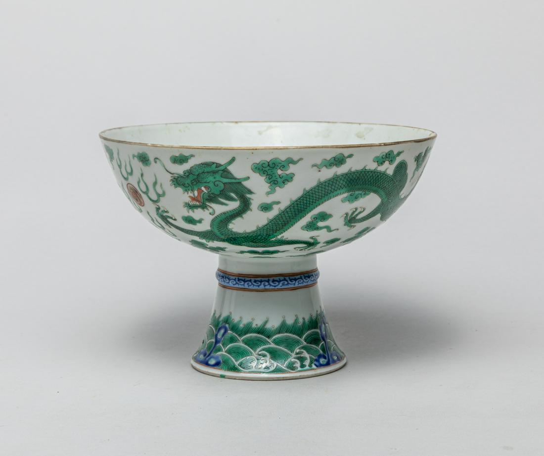 Large Chinese Famille Rose Porcelain Tall Bowl: The rounded sides exterior enameled in green tone with a pair of four-clawed dragons chasing flaming pearls amidst scrolling clouds, supported on a spreading foot painted with waves and rocks. 6.8inch