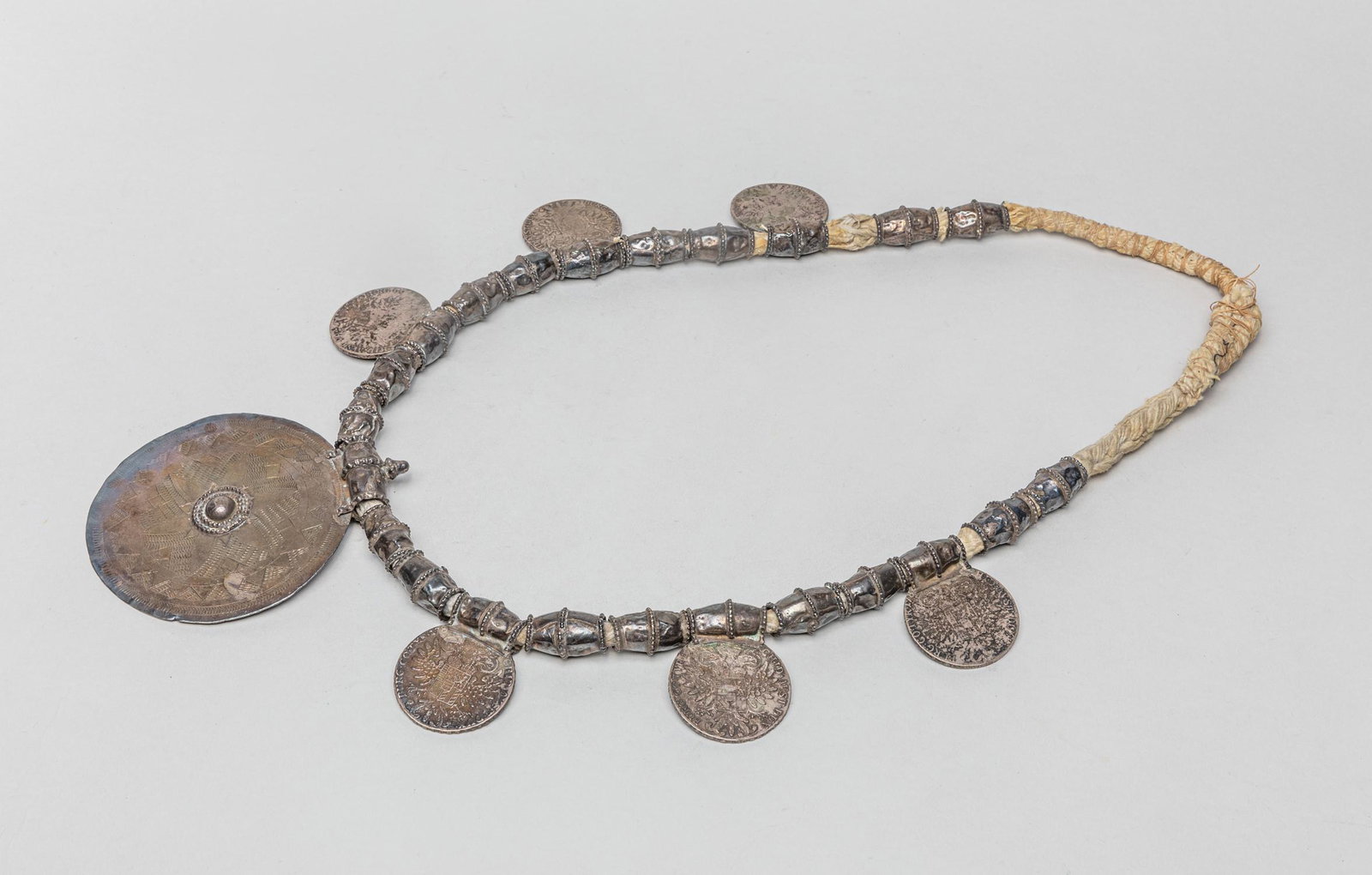 Austria Maria Theresa Silver Thaler Necklace: Collectible Austrian necklace with silver thaler and pendant carved with vintage patterns and portraits. 33inch L.