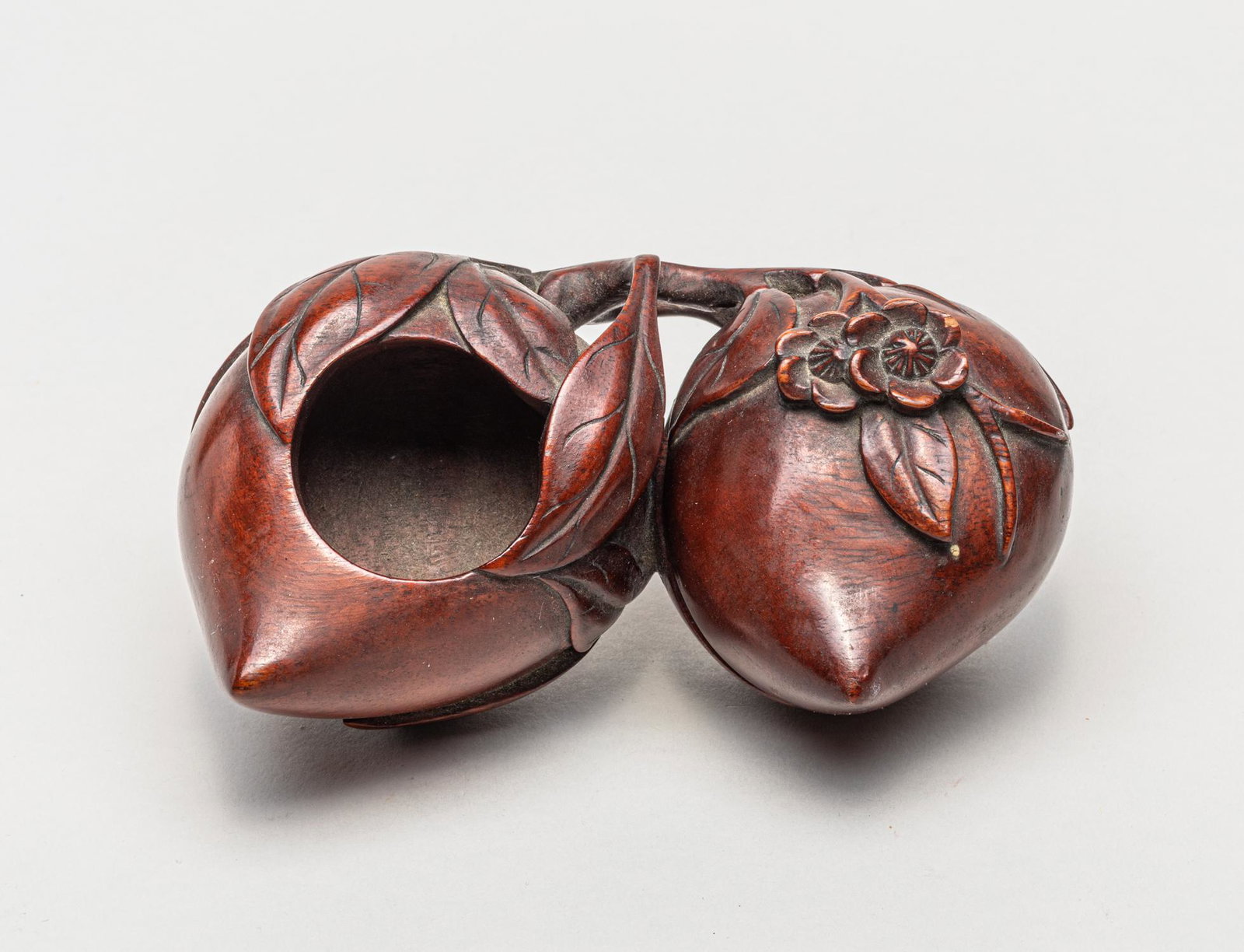 Chinese Wood Carved Washer: Skillfully carved as two peaches borne on a stem issuing leaves and flowers, one peach hollowed and the other with a cover, the wood surface well smoothed. 5.5inch L, 2.9inch W, 2.2inch H.