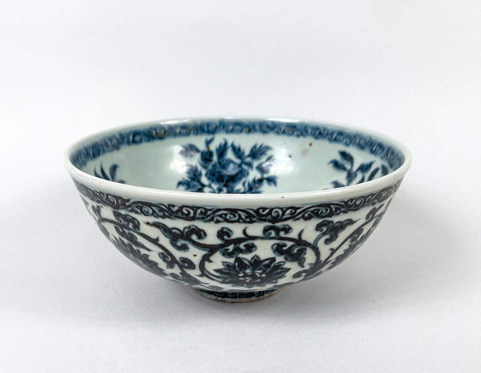 Large Chinese Export Porcelain Bowl: The interior centre painted with a band of lotus petals enclosing lotus, surrounded with gourd blossoms and leaves, the exterior with meandering lotus sprays. 8.75inch W, 4.2inch H.