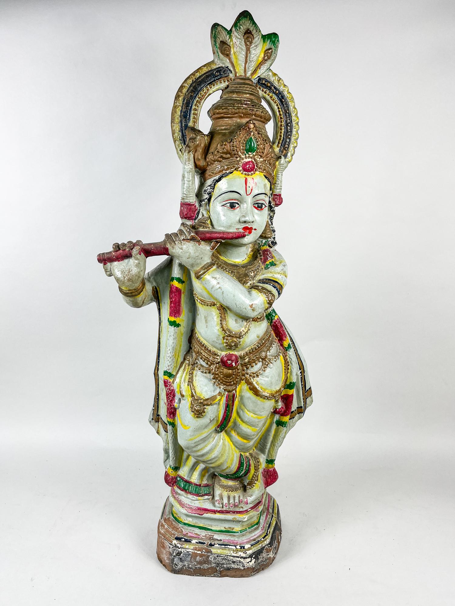 Tall Indian Buddha of Shiva: Collectible Indian style Buddha Shiva sculpture, modeled standing with hands playing a flute, dressed in loose-fitted robe and dhoti and decorated with bead jewelry. Approx. 34.5inch H, 13.5inch L, 6i