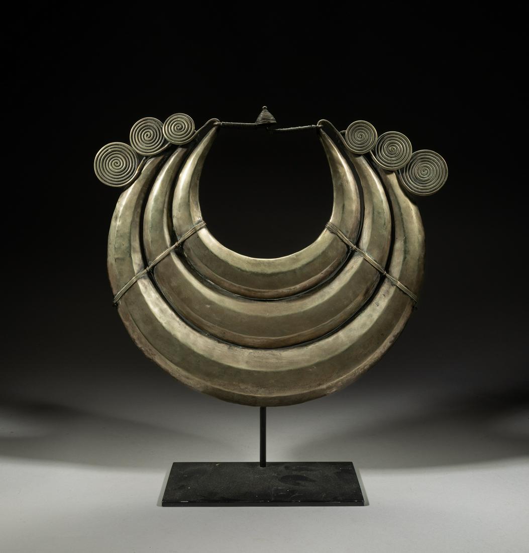 Massive African Tribe Metal Chocker Necklace: Modeled in the form of three bundled horn type chokers with scrolling metal cords, with stand. 17.7inch H, 16.2inch W (w/ stand).
