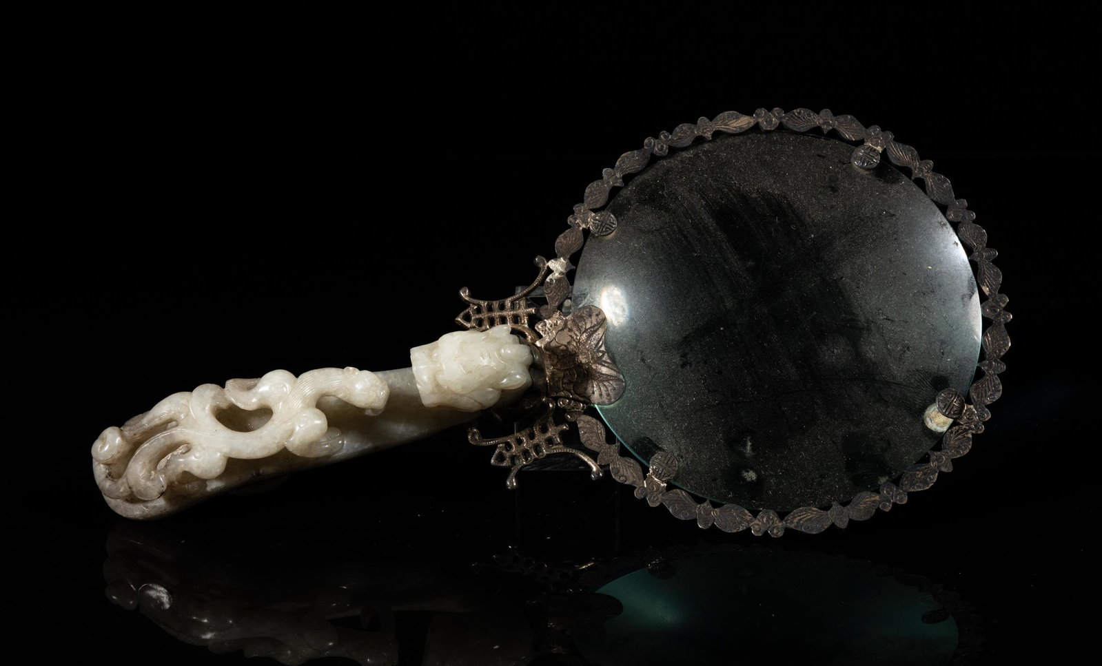 Antique Chinese Jade Handle Magnifying Glass: The grayish white jade handle carved with a chilong clambering along the shaft confronting a dragon head terminal, the back with a circular knob for attachment, the fittings carved with a band of bats