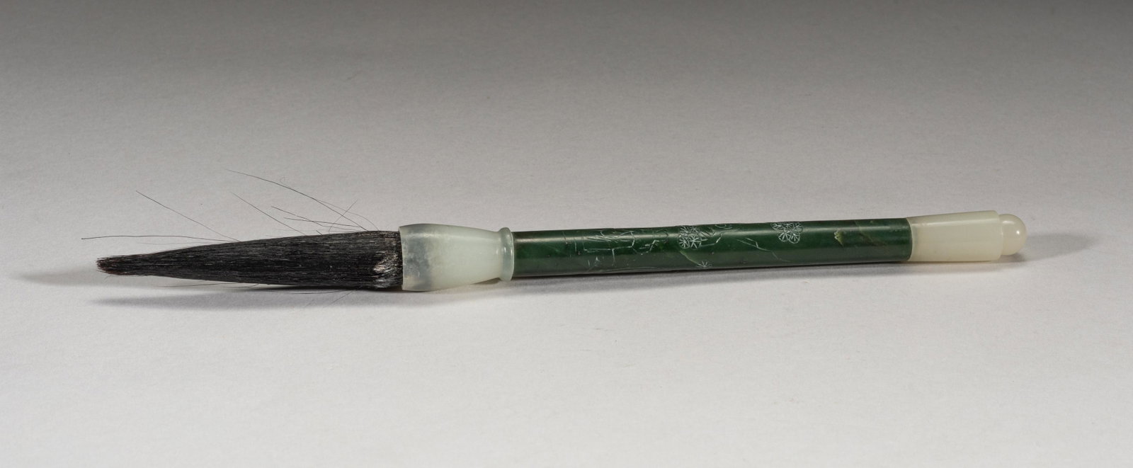 Chinese White Jade & Spinach Jade Brush Pen: Collectible white jade and spinach jade brush pen, the spinach jade shaft carved in low relief with a scholar, a gnarled pine tree and craggy rockwork. 9.6inch L.