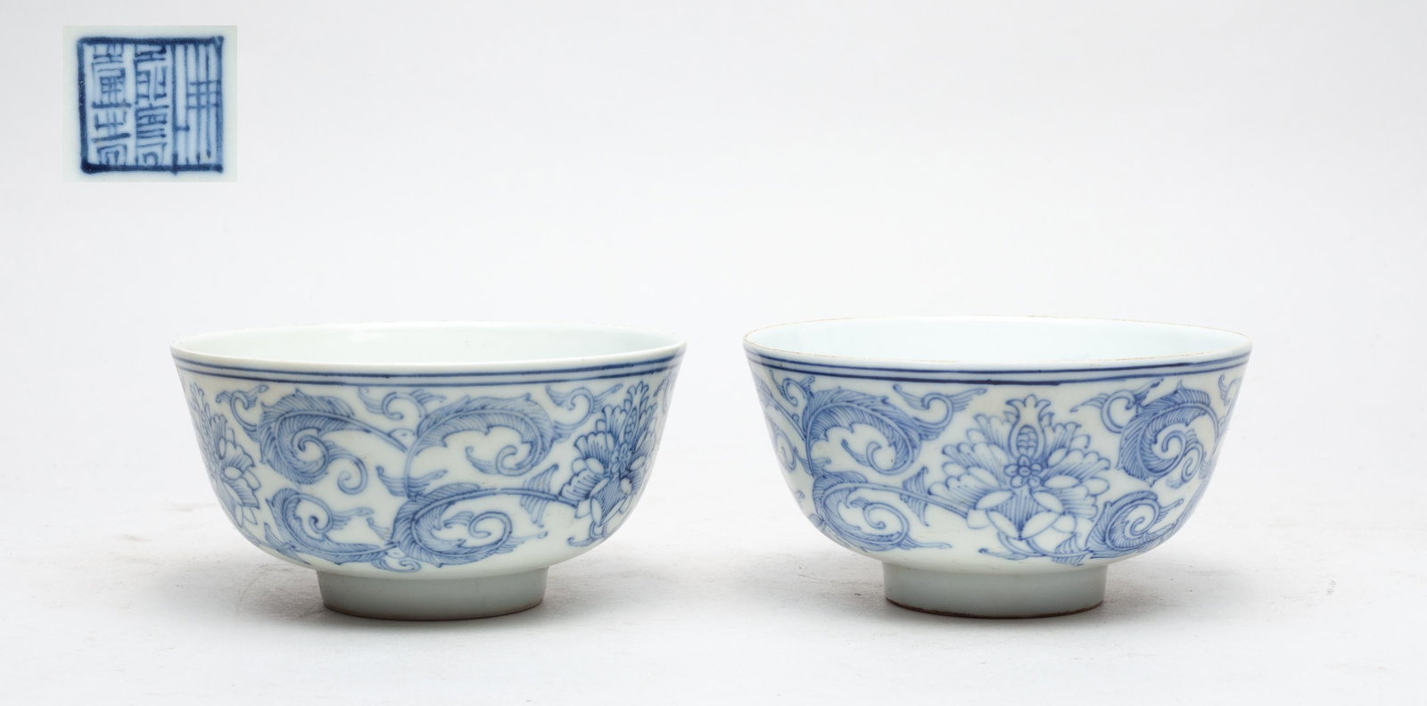 Pair Chinese Blue & White Porcelain Lotus Bowls: The rounded side painted with meandering leafy lotus sprays, the base with a seal mark. 4.5inch W, 2.4inch H (each).