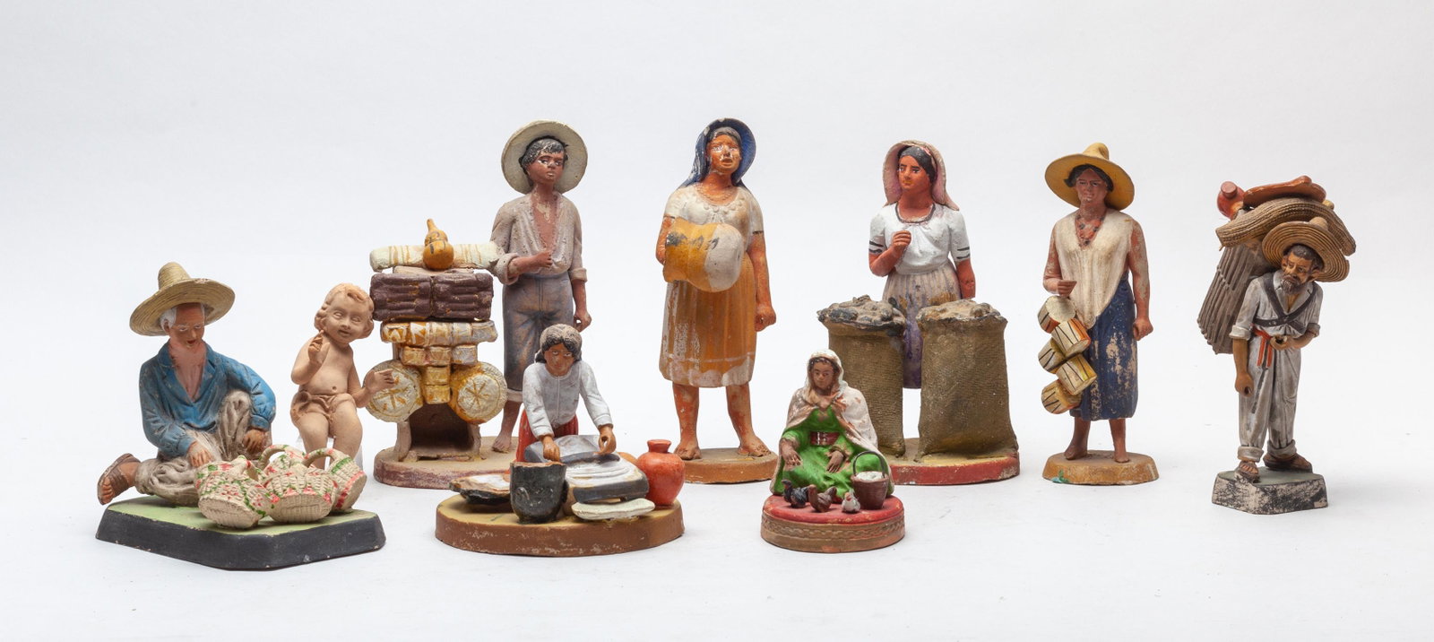 Collectible Mexico Old Clay Figures: Group of nine special Mexican type clay figure sculptures, modeled as figures in various activities or a happy child. 4.1inch L, 3inch W, 6.3inch H (largest).