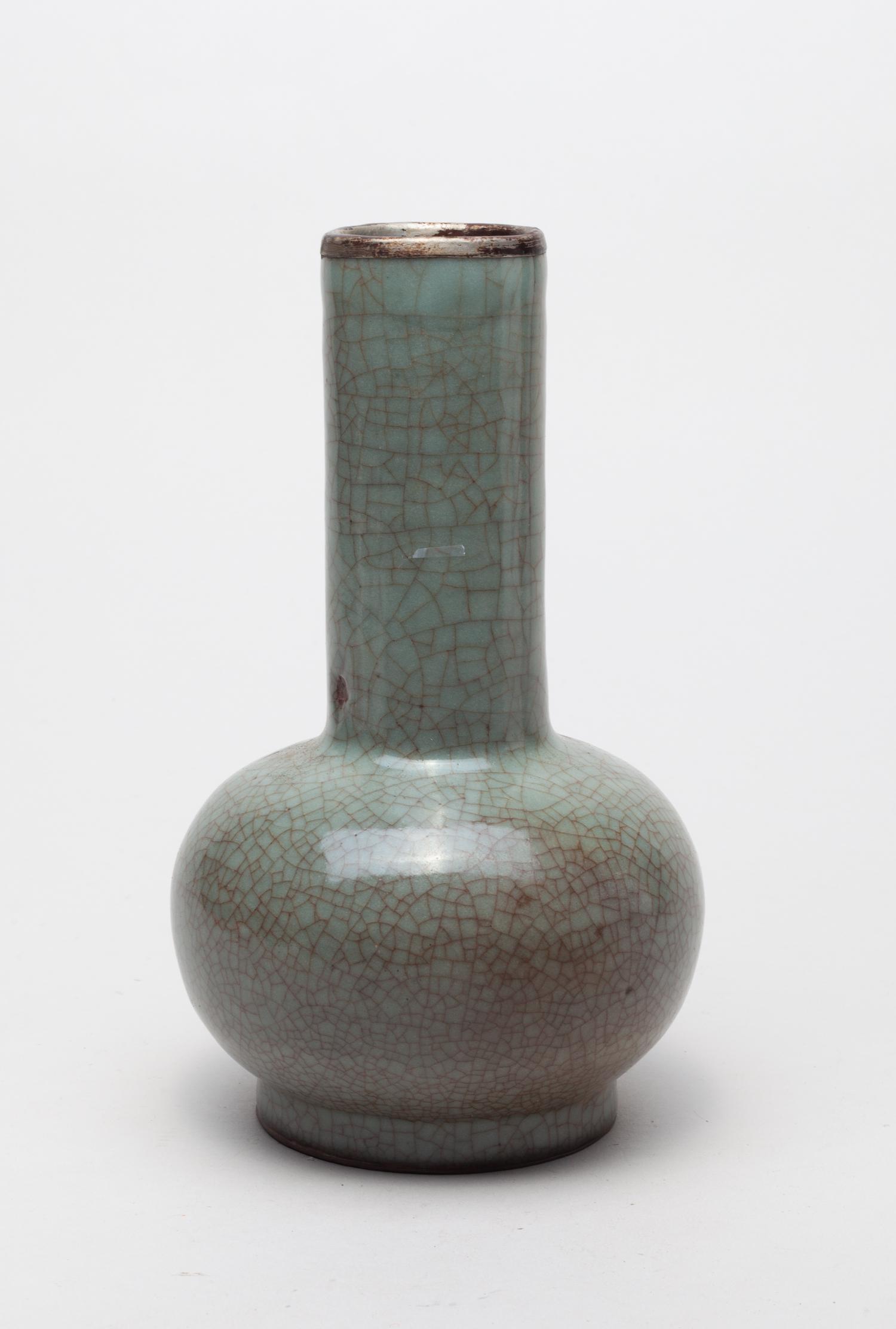 Chinese Ge Ware Porcelain Vase: The compressed globular body rising from a short neck to a tall columnar neck, covered overall with a bluish gray glaze suffused with a matrix of brown crackles. 4.7inch W, 8inch H. The estate of DTLA