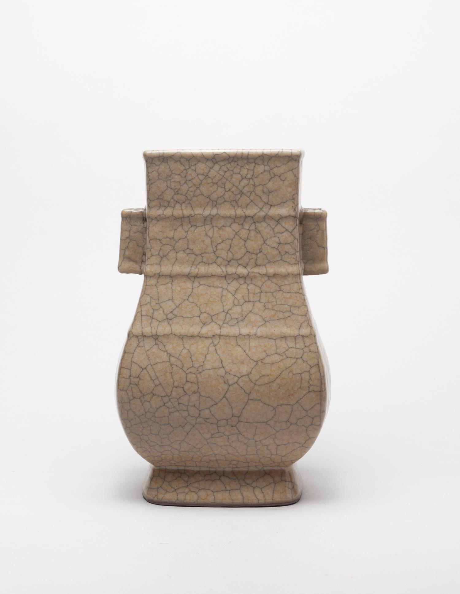 Large Chinese Ge Ware Porcelain Vase: Of square section, the pear-shaped body tasing from a spreading foot to a lipped mouth, the body set with three horizontal raised fillets and the neck flanked by a pair of faceted lug handles, covered