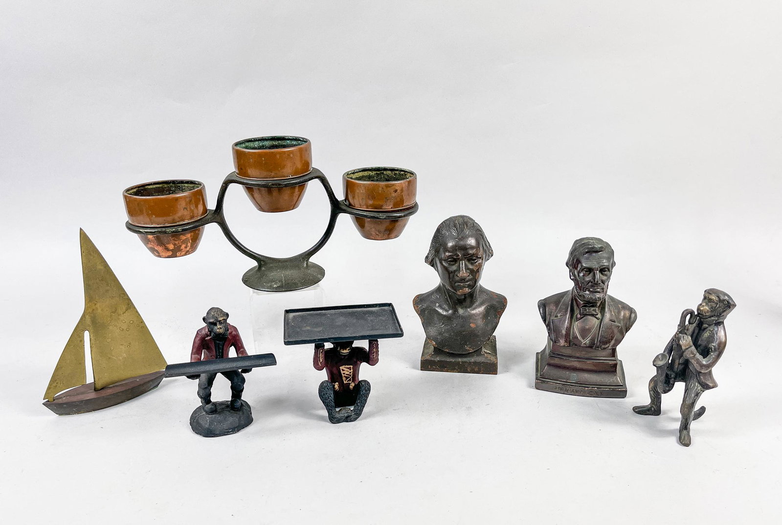Rare Bronze/Metal Table Art Wares: Seven pieces as a group, including a candelabrum, a sailboat, two figure bust sculptures, three monkey type table sculptures. 11.4inch L, 3.4inch W, 5.5inch H (largest).