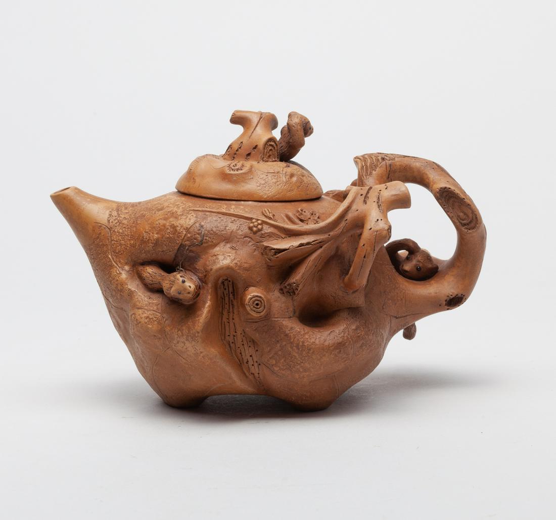 Chinese Special Form Zisha Tea Pot: Skillfully modeled in gnarled branch form, detailed with flowers and a squirrel on the body, the handle and the cover knob carved with a monkey extending from the branch, the bottom marked with two ch
