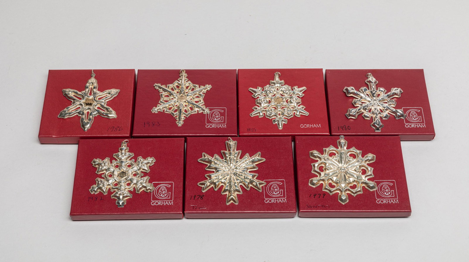 Collectible Gorham Sterling Snowflake: Group of seven Gorham annual sterling snowflake decors, each with a bag and a box, the underside marked Gorham Sterling Christmas 1978/1979/1982/1983/1984/1986 or Gotham Silver-plate 1980. 3.47inch W