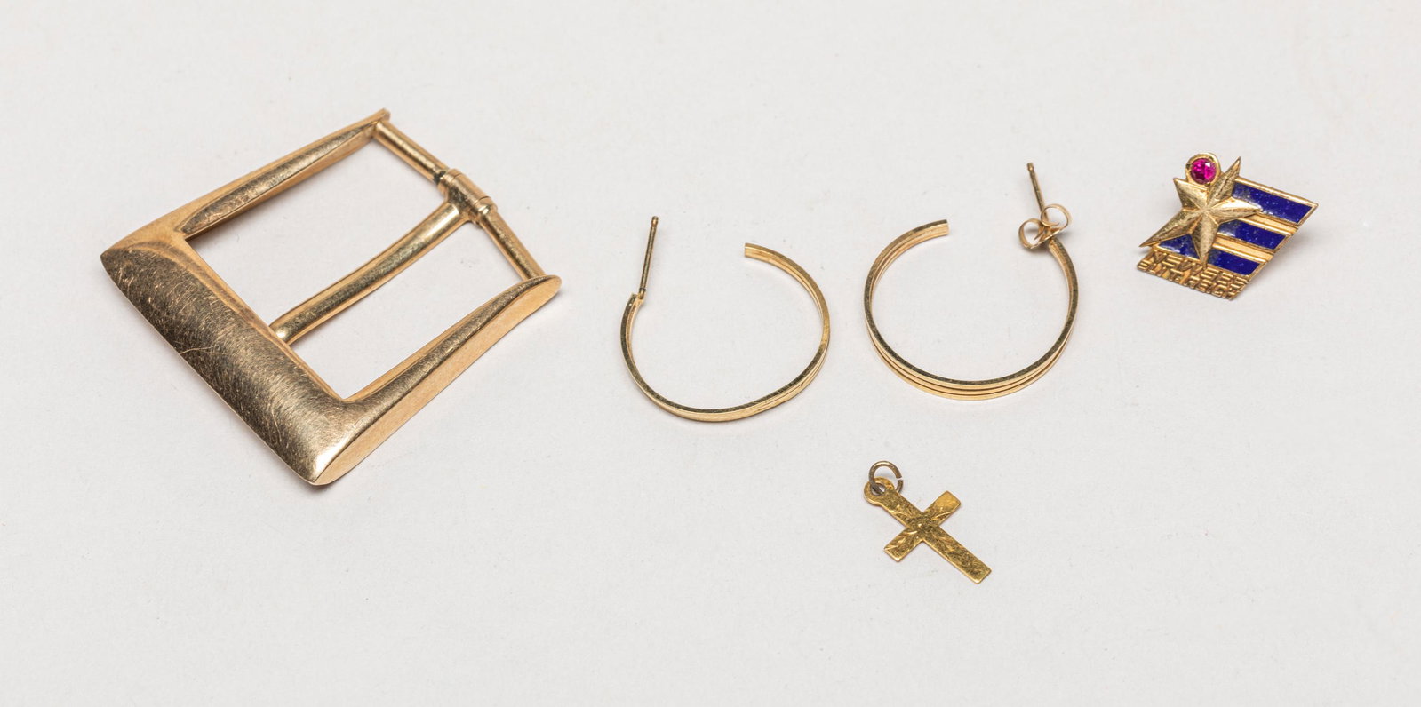Set 10k Gold Earrings, Buckle & Pendant: Including a pair of earrings, a cross type pendant, a badge and a buckle, each piece marked 10K. 8.9gram (total weight), 1.4inch L, 1.35inch W (pendant size).