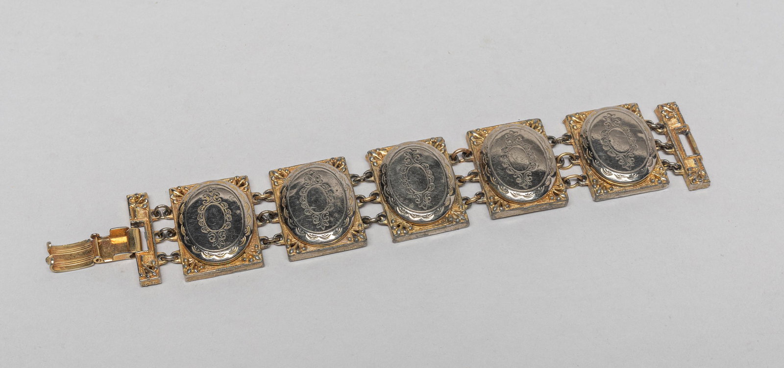 France Louis XVI Type Photo Locket Bracelet: French vintage style locket picture bracelet, with exquisite ornate engraved designs, marked Hattie Carnegie. 7inch L.