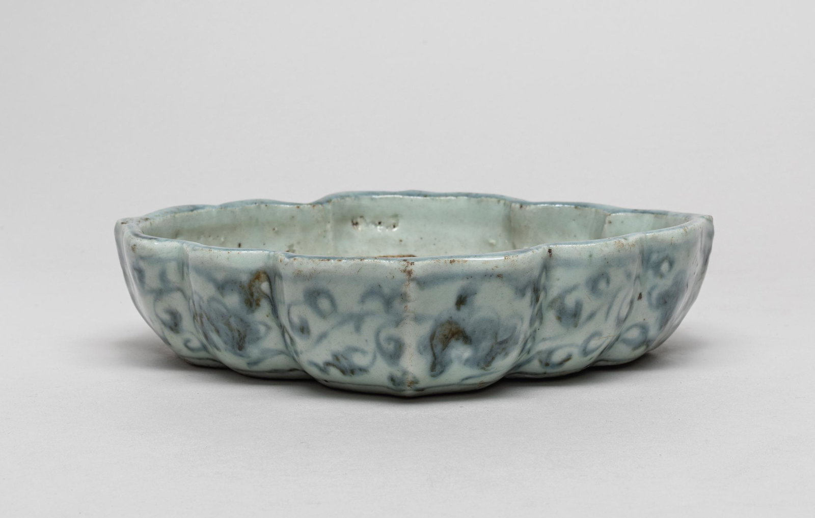 Important Korean Blue & White Porcelain Washer: The lobes sides painted around the exterior with undulating leafy lotus scrolls, the unglazed interior and base revealing the porcelain body. 7.9inch L, 7inch W, 1.8inch H.
