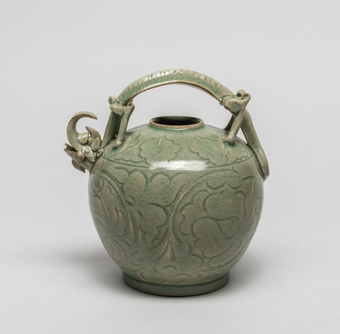 Rare Korean Turtle Dragon Porcelain Pot: The ovoid body carved the exterior in low relief with large lotus blooms borne on meandering leafy scrolls, beneath a band of overlapping leaves, surmounted with stylized turtle drawing handle, covere