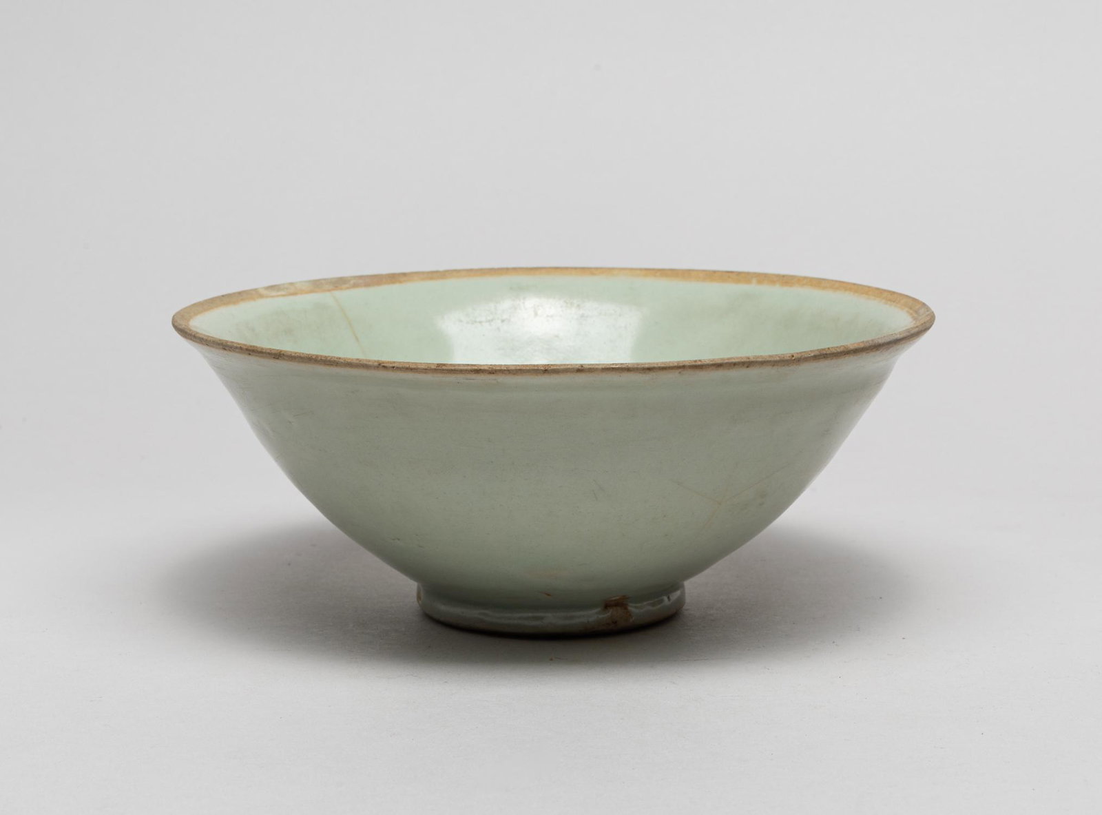 Korean Early Shipwreck Porcelain Bowl: The rounded sides covered the inside and out with a pale seafoam green glaze save for the rim. 7.1inch H, 2.8inch W.
