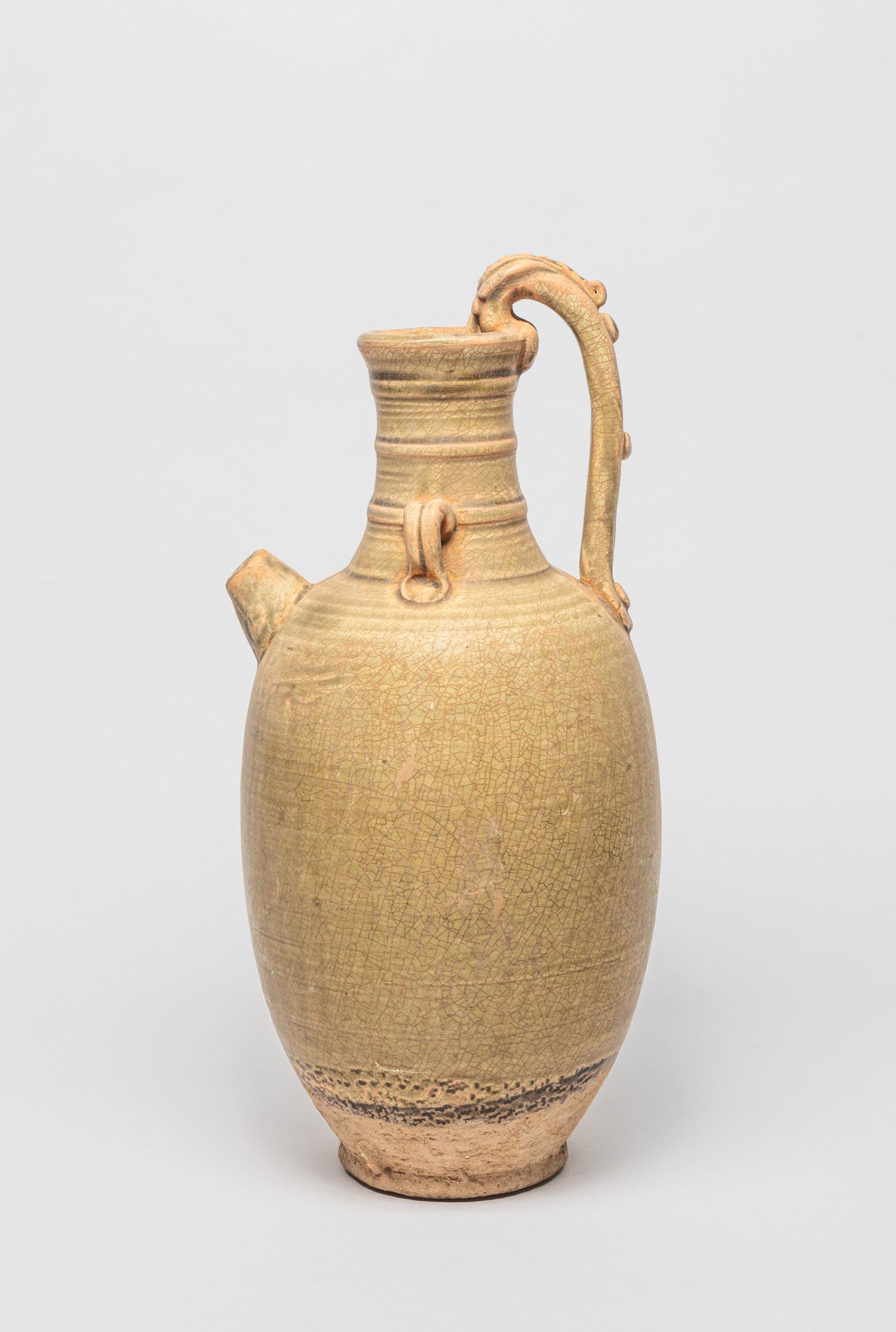 Tall Chinese Yue Ware Porcelain Vase: Tall South China Yue stoneware glazed porcelain vase, the ovoid body rising from a short foot to a waisted neck, set with three parallel borders at the neck, applied in a crackled beige glaze. 13.5 in